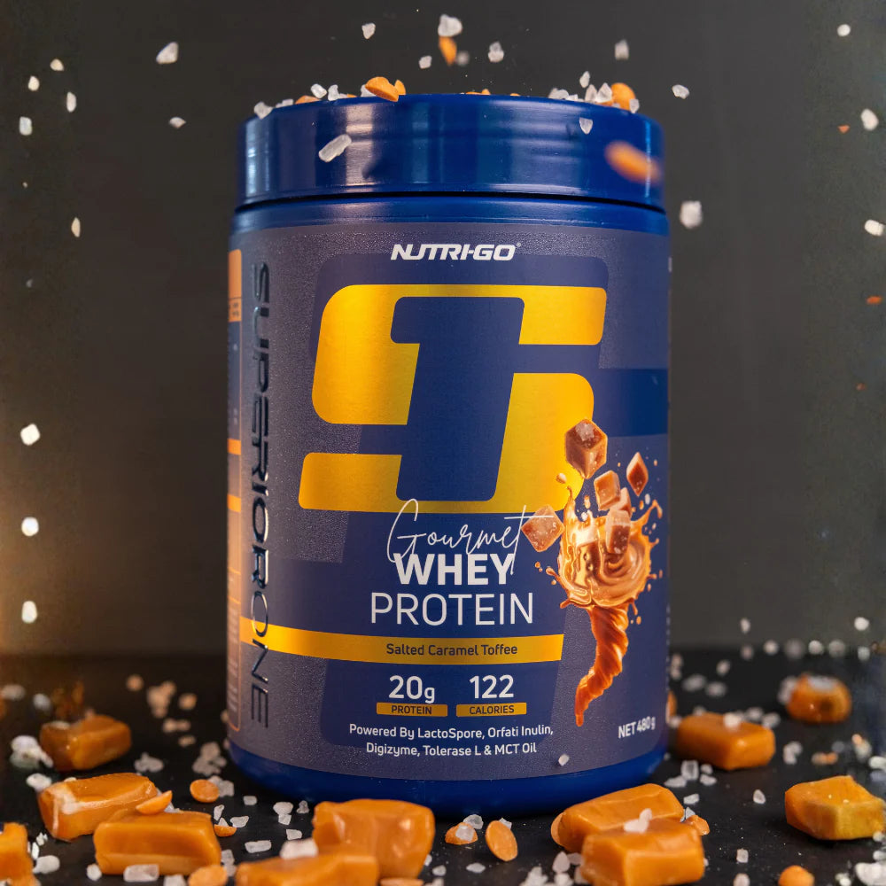 NUTRIGO Gourmet Whey Protein container with caramel pieces on a dark background Muscle Mecca