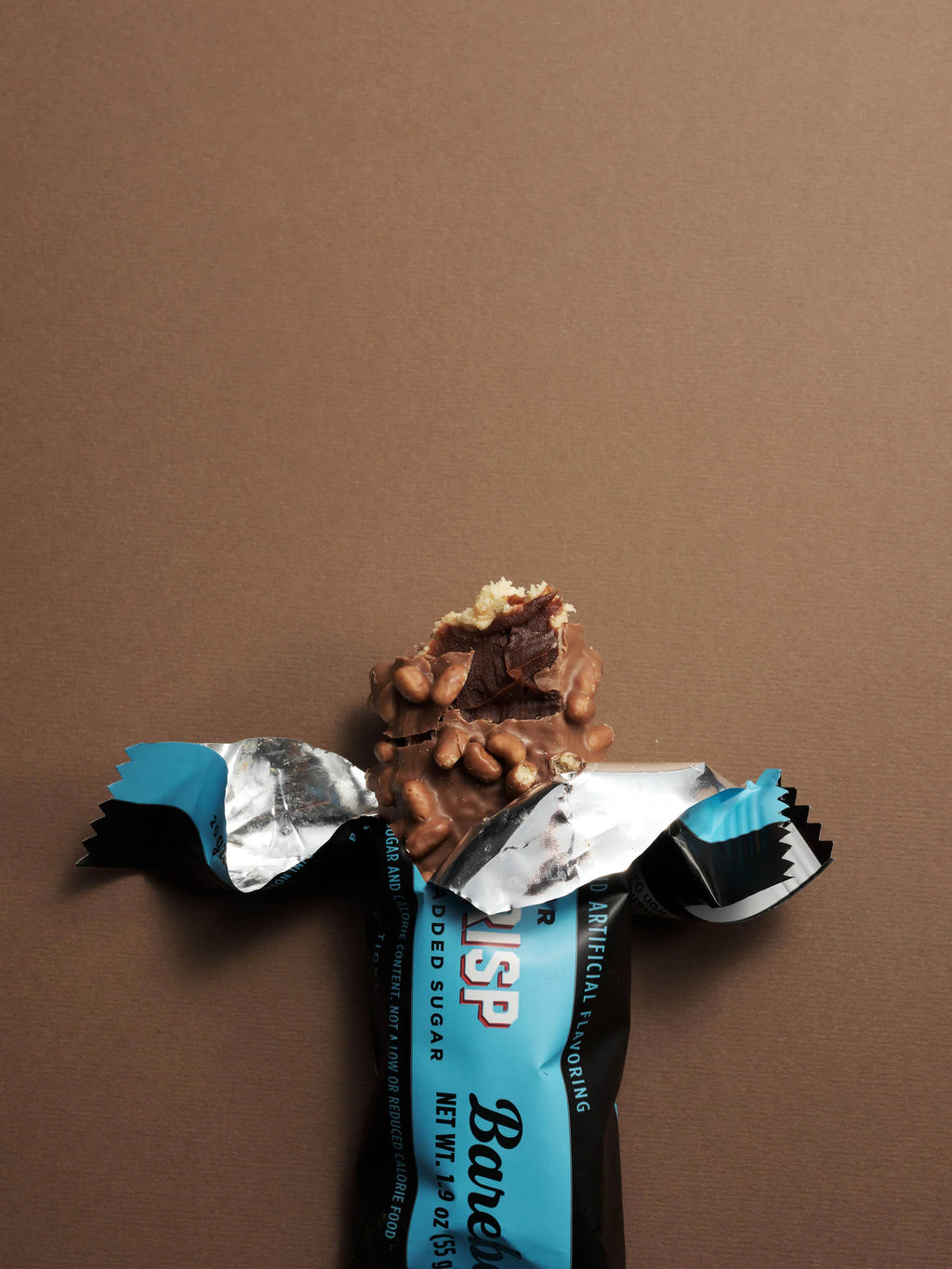 Worn-out chocolate bar with a blue wrapper on a brown background Muscle Mecca