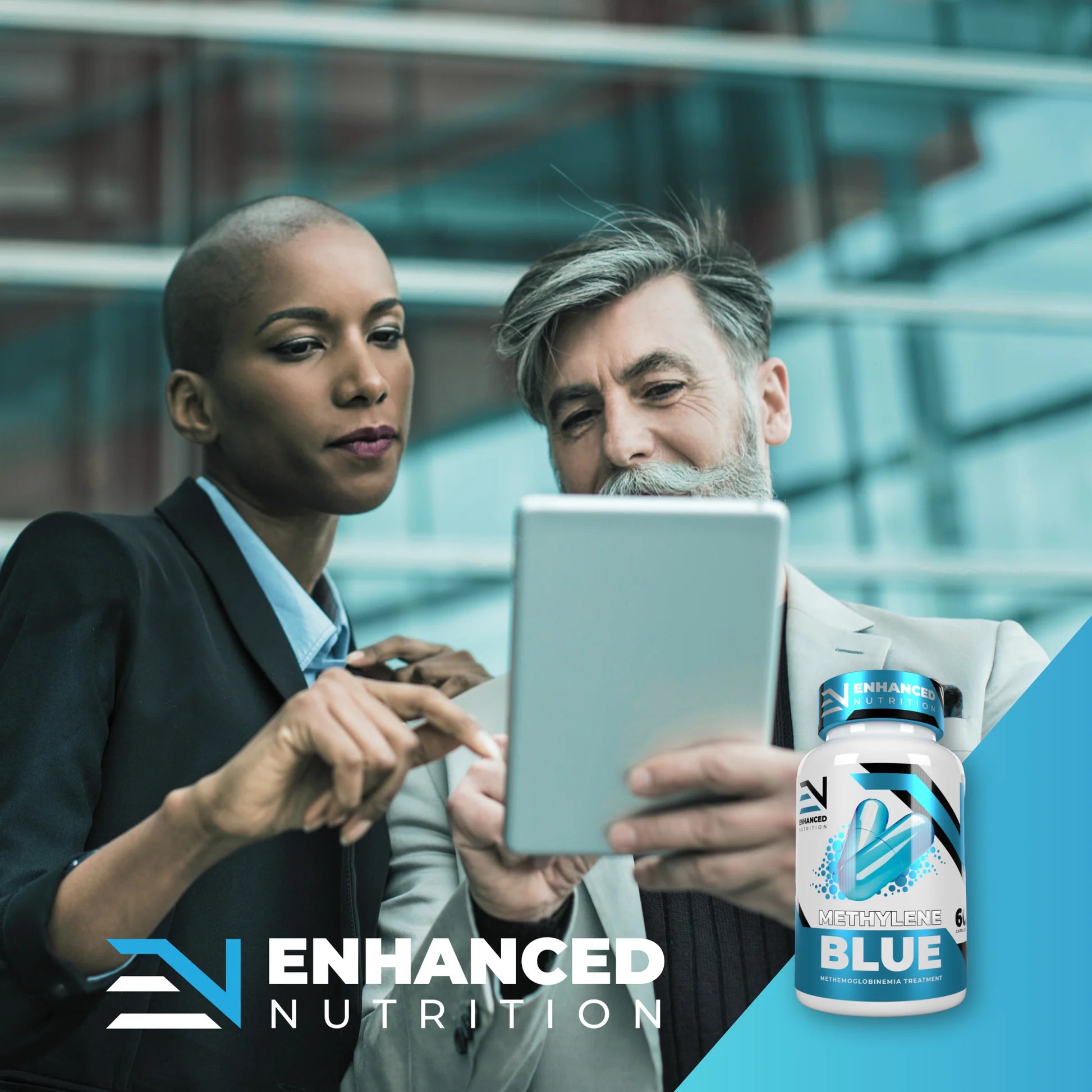 Two people looking at a tablet with Enhanced Nutrition supplement bottle displayed. Methylene Blue Muscle Mecca 3