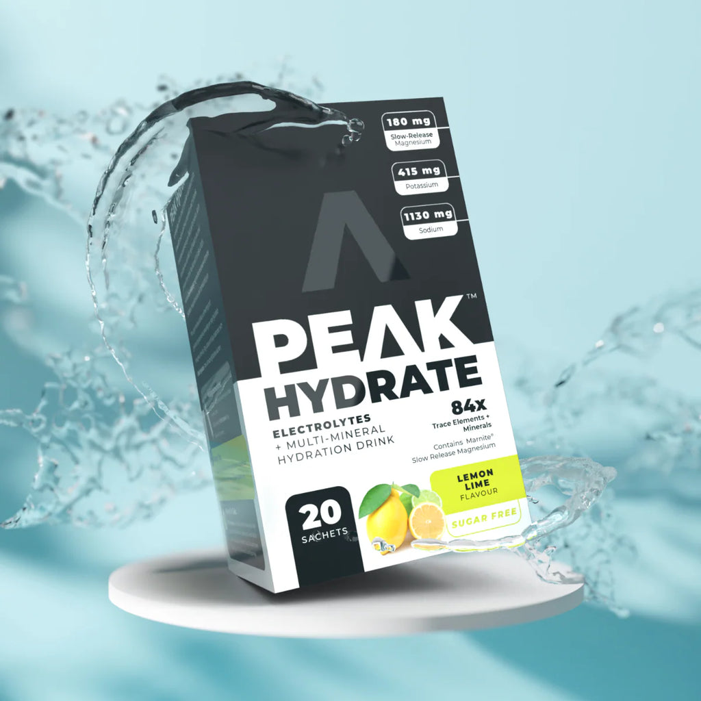 Peak Hydrate electrolytes multi-mineral hydration drink package on a light blue background with water effects. Muscle Mecca
