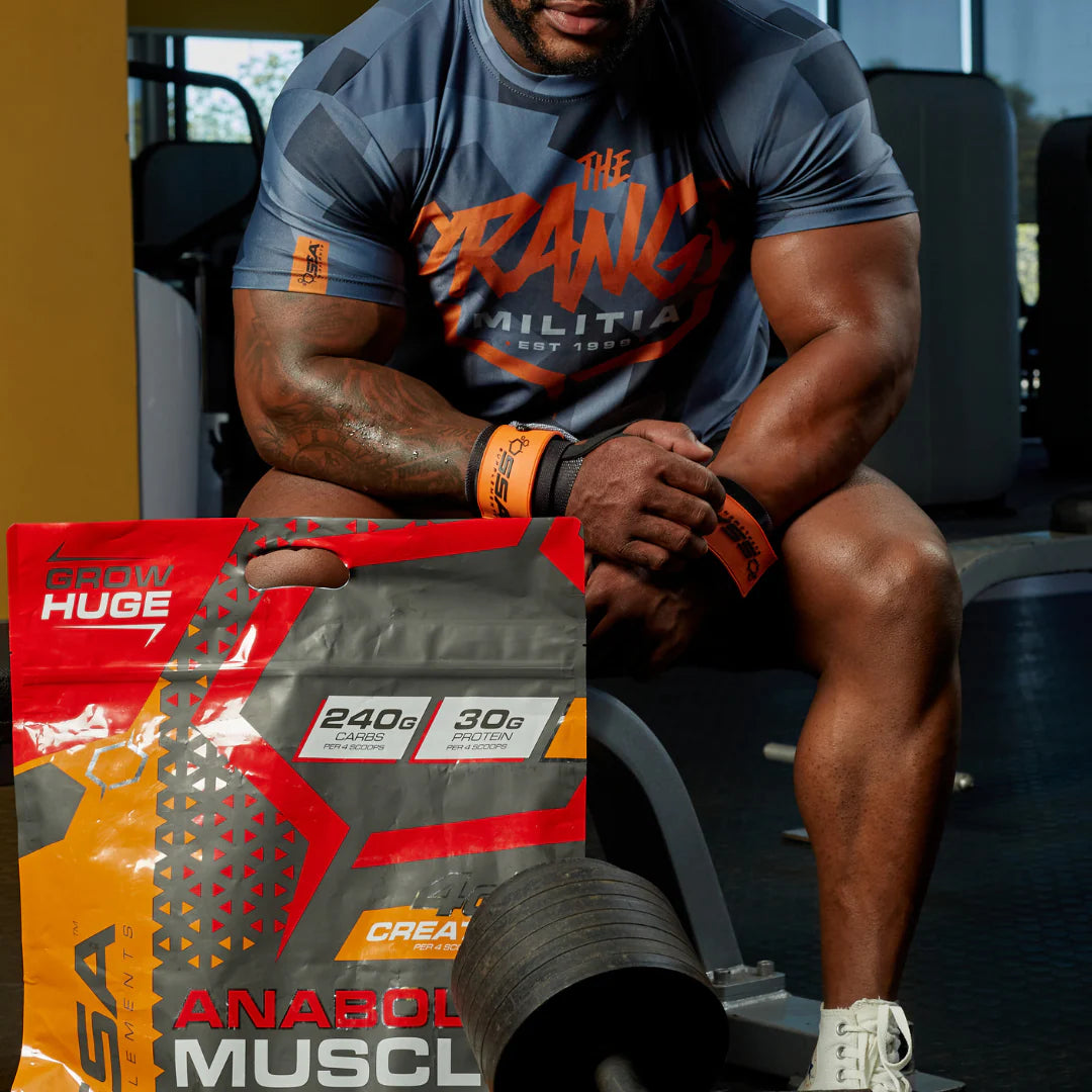 Person in a gym setting with a supplement package in the foreground SSA Anabolic Muscle Muscle Mecca
