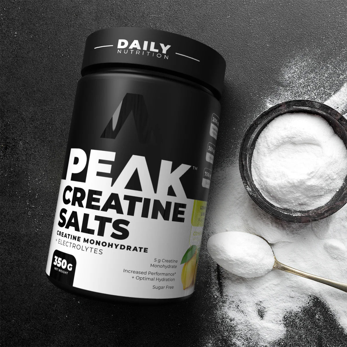 Container of Peak Creatine Salts with a scoop of powder on a dark background Muscle Mecca