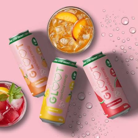 Three GLOOT Sparkling Energy drink cans arranged on a pink background with water droplets, alongside a glass of iced peach drink and a glass of iced red drink.